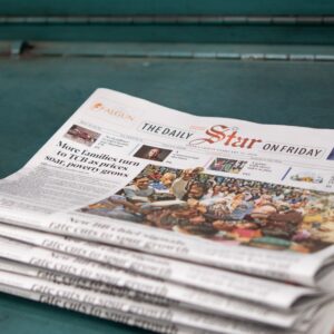 Stack of 'The Daily Star' newspapers showcasing a headline on rising poverty and price issues.